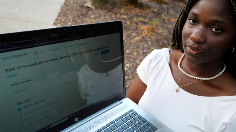 Adjovi Golo holds a laptop at DePaul University in Chicago, Wednesday, Aug. 28, 2024. (Nam Y. Huh / AP Photo)