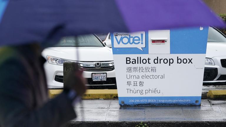 A pedestrian walks past a King County ballot drop box, closed until ballots are mailed about three weeks before the election, on a Seattle street Thursday, Sept. 24, 2020. (AP Photo / Elaine Thompson)