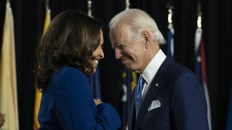 Democratic presidential candidate former Vice President Joe Biden and his running mate Sen. Kamala Harris, D-Calif., pass each other as Harris moves to the podium to speak during a campaign event at Alexis Dupont High School in Wilmington, Del., Wednesday, Aug. 12, 2020. (AP Photo / Carolyn Kaster)
