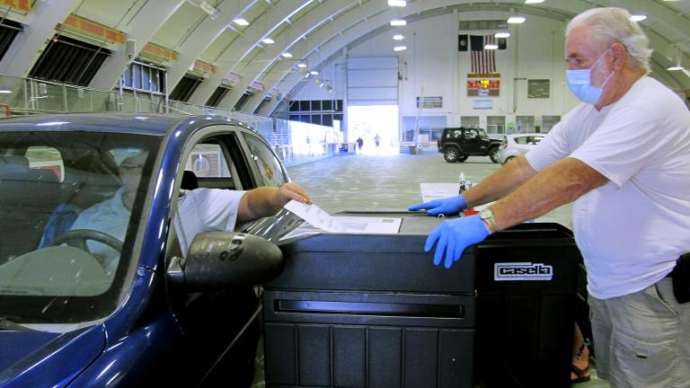 In this Aug. 11, 2020, file photo, a voter casts a ballot at a drive-thru voting station in the Barre Civic Center in Vermont’s statewide primary in Barre, Vt. (AP Photo / Lisa Rathke, File)