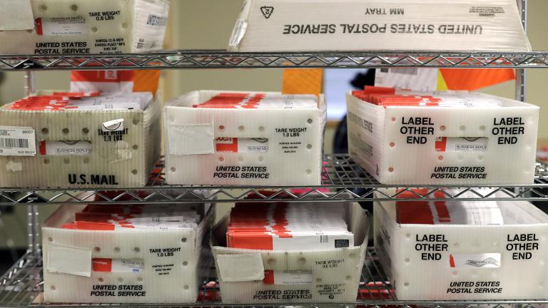 In this Aug. 5, 2020, file photo vote-by-mail ballots are shown in U.S. Postal service sorting trays the King County Elections headquarters in Renton, Wash., south of Seattle. (AP Photo / Ted S. Warren, File)