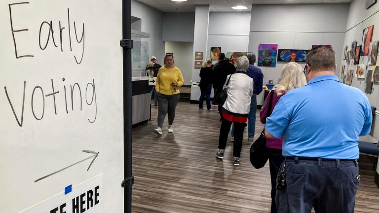 People wait in line to early vote for the U.S. Senate runoff election in Georgia between Sen. Raphael Warnock and challenger Herschel Walker, on Nov. 28, 2022, in Kennesaw, Ga., near Atlanta. (AP Photo / Mike Stewart, File)