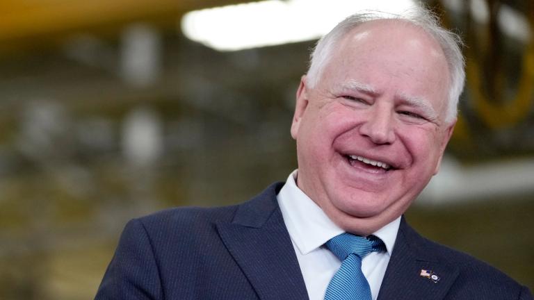 Minnesota Gov. Tim Walz, right, laughs as he stands with Fridley, Minn., Mayor Scott Lund during a visit to the Cummins Power Generation Facility in Fridley, Minn., Monday, April 3, 2023. (AP Photo / Carolyn Kaster, File)