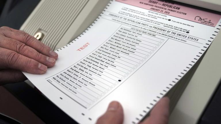 Nick Zaharias of Derry, N.H., a public witness, loads a test ballot into a vote counting machine while testing machines before the New Hampshire primary, at the Derry Municipal Center, Tuesday, Jan. 16, 2024. (AP Photo / Charles Krupa)