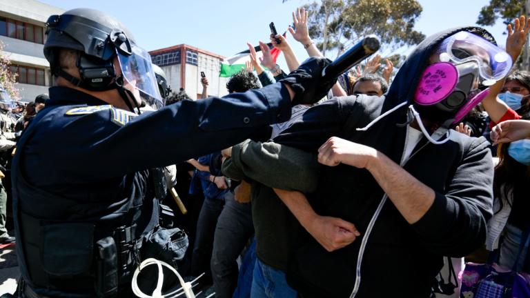 FILE - A protester is hit with a baton by a police officer at UC San Diego, May 6, 2024, in San Diego. (Denis Poroy / AP Photo, File)