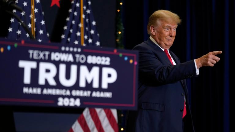 Former President Donald Trump greets supporters as he arrives at a commit to caucus rally, Tuesday, Dec. 19, 2023, in Waterloo, Iowa. (Charlie Neibergall / AP Photo)
