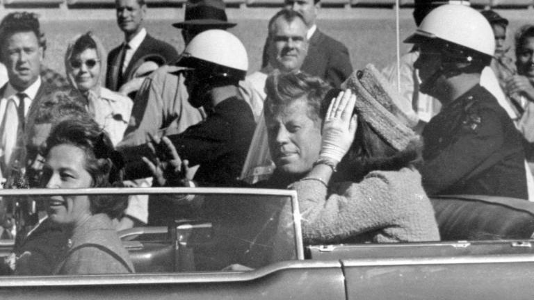 President John F. Kennedy waves from his car in a motorcade approximately one minute before he was shot, Nov. 22, 1963, in Dallas. Riding with President Kennedy are first lady Jacqueline Kennedy, right, Nellie Connally, second from left, and her husband, Texas Gov. John Connally, far left. (AP Photo / Jim Altgens, File)