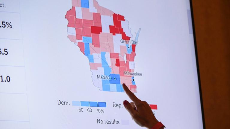 A supporter of Wisconsin Republican gubernatorial candidate Tim Michels points to the incoming state-wide data of the Wisconsin governor'’s race during an election night campaign event for Michels at the Italian Community Center, Nov. 8, 2022, in Milwaukee. (AP Photo / Kenny Yoo, File)