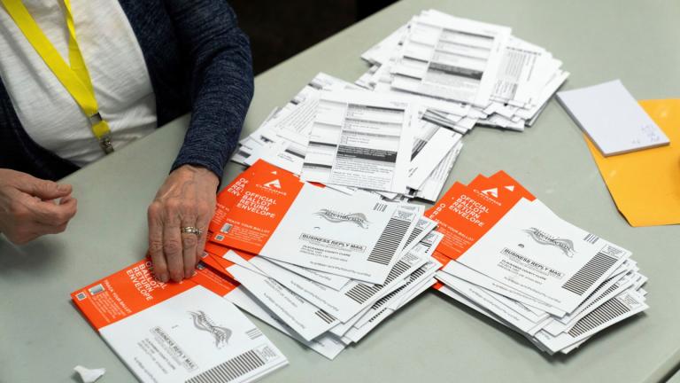 An election worker reaches for an unopened ballot during sorting at the Clackamas County Elections office, Nov. 7, 2024, in Oregon City, Ore. (AP Photo / Jenny Kane, File)