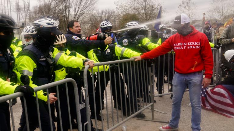 Demonstrators loyal to President Donald Trump, are sprayed by police, Wednesday, Jan. 6, 2021, during a day of rioting at the Capitol. (AP Photo / John Minchillo)