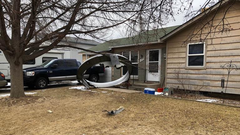 In this photo provided by the Broomfield Police Department on Twitter, debris is scattered in the front yard of a house at near 13th and Elmwood, Saturday, Feb. 20, 2021, in Broomfield, Colo. (Broomfield Police Department via AP)