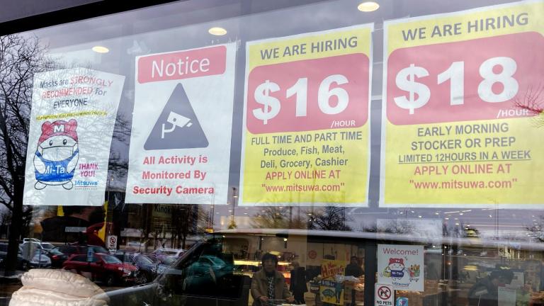 Hiring signs are displayed at a grocery store in Arlington Heights, Ill., Friday, Jan. 13, 2023. (AP Photo / Nam Y. Huh, File)