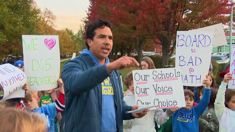 Families protest the proposed closures of two Evanston elementary schools, Oct. 26, 2026. (WTTW News)