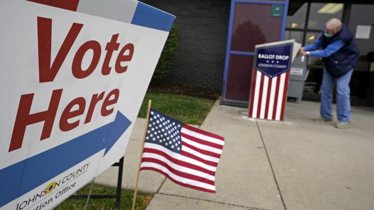A voter deposits his advance ballot in a dropbox Tuesday, Oct. 20, 2020, in Mission, Kan. (AP Photo / Charlie Riedel, File)
