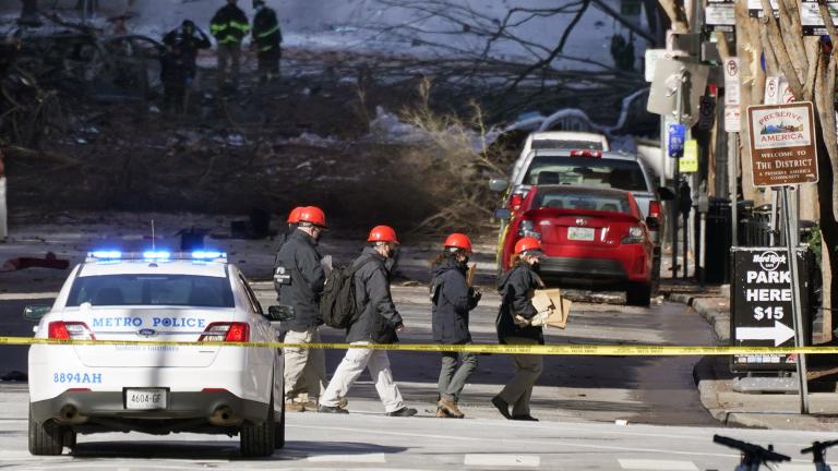 Investigators walk near the scene of an explosion Saturday, Dec. 26, 2020, in Nashville, Tenn. (AP Photo / Mark Humphrey)
