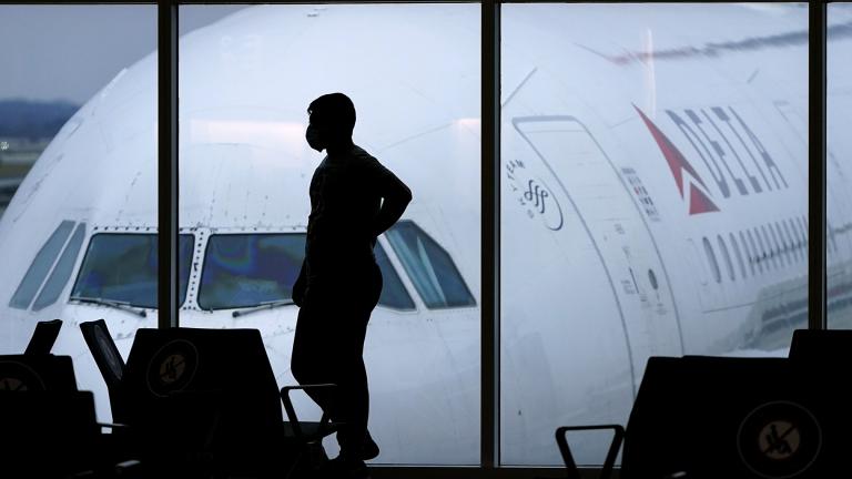 In this Feb. 18, 2021 file photo, a passenger wears a face mask to help prevent the spread of the new coronavirus as he waits for a Delta Airlines flight at Hartsfield-Jackson International Airport in Atlanta. (AP Photo / Charlie Riedel, file)