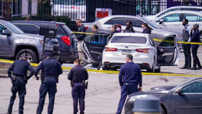 Law enforcement confer at the scene, Friday, April 16, 2021, in Indianapolis, where multiple people were shot at a FedEx Ground facility near the Indianapolis airport. (AP Photo / Michael Conroy)