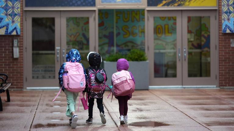 Three sisters, whose single mother fears being mistakenly detained by federal immigration agents because she is of Puerto Rican descent and speaks Spanish, walk into Funston Elementary School after being dropped off for the start of the school day, in Chicago’s Logan Square neighborhood, Wednesday, Oct. 15, 2025. (AP Photo / Rebecca Blackwell)