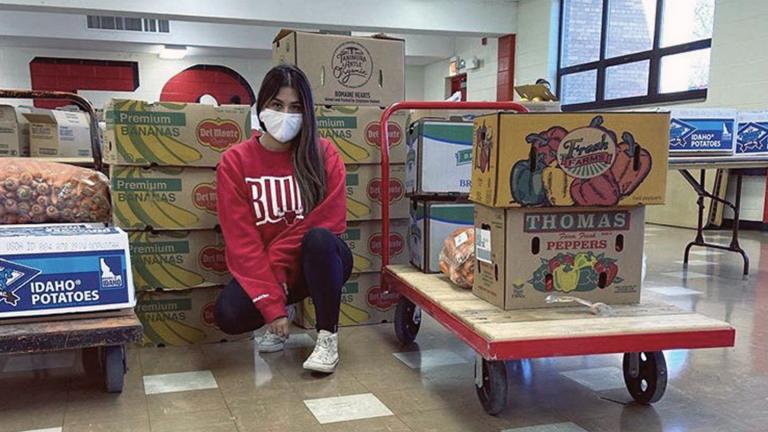 Elizabeth Morales, founder of Del Dia Chicago, sits with boxes of fresh produce she gets every week from farmers. (Courtesy Elizabeth Morales)