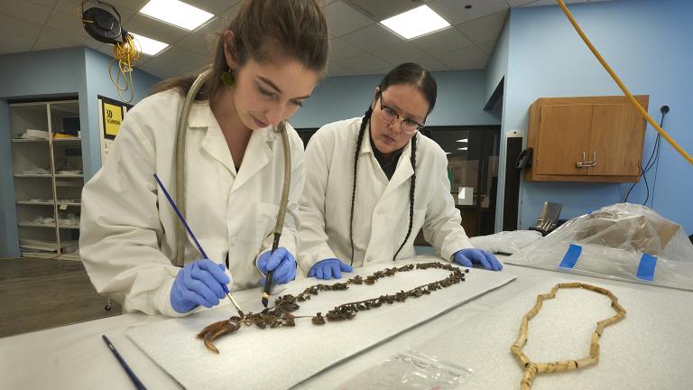 Field Museum conservation technicians Ellen Jordan and J. Kae Good Bear work on the care of cultural materials in the Regenstein Lab. (© Field Museum, photo by John Weinstein)