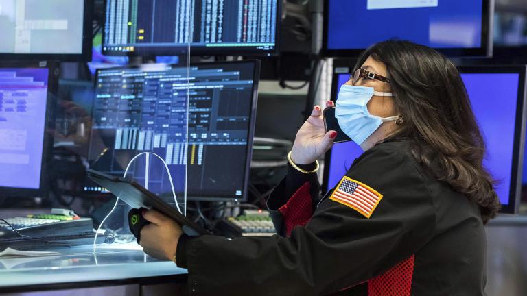 In this photo provided by the New York Stock Exchange, trader Phyllis Arena Woods works on the floor, Monday, Jan. 24, 2022. (Courtney Crow / New York Stock Exchange via AP)