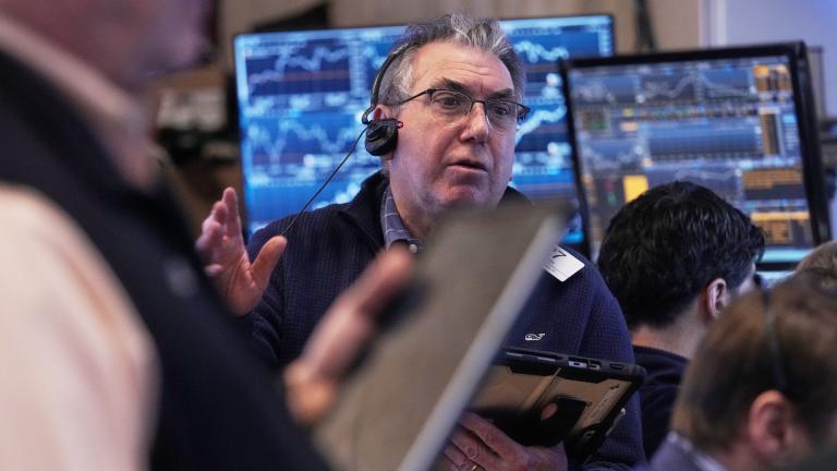 Trader John Bishop works on the floor of the New York Stock Exchange, Friday, Feb. 20, 2026. (AP Photo/Richard Drew)