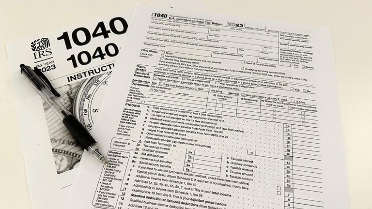 An Internal Revenue Service 2023 1040 tax form and instructions are shown on Friday, Jan. 26, 2024. For many people filing U.S. tax returns — especially those doing it for their first time — it can seem like a daunting task. (AP Photo / Peter Morgan)