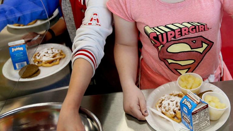 FILE - Students line up for lunch at a middle school in Sandy, Utah, May 19, 2017. (Laura Seitz / The Deseret News via AP, File)