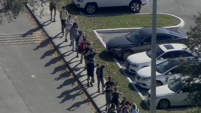 Students are evacuated from Marjory Stoneman Douglas High School on Feb. 14, 2018 after a gunman opened fire.