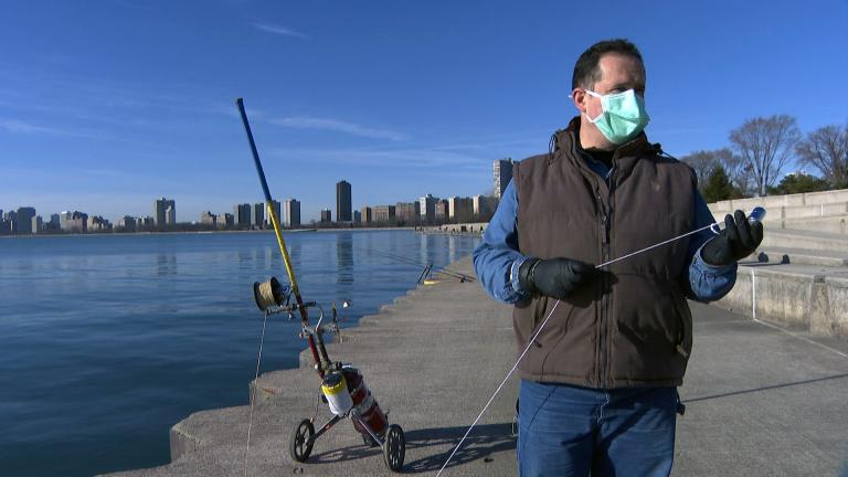 Florin Deleanu powerline fishes at Montrose Harbor in Chicago on March 12, 2021. (WTTW News)