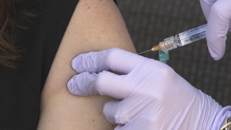 A flu vaccine is administered to National Foundation for Infectious Diseases (NFID) staff members in Bethesda, Md., on Wednesday, Sept. 30, 2020. (AP Photo/Federica Narancio)