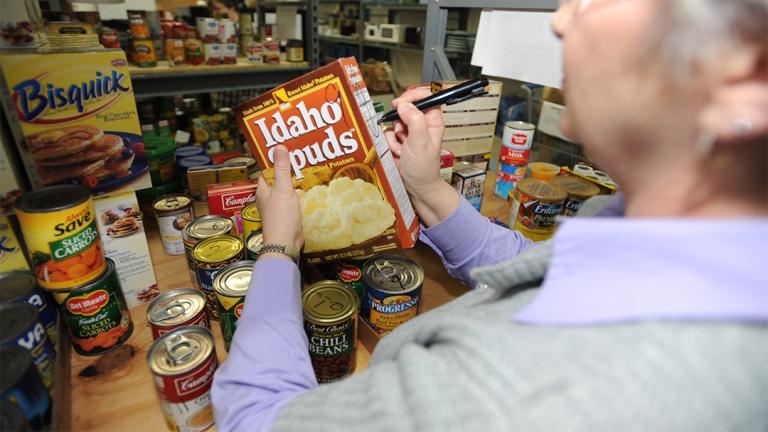 A staff member stocks the shelves of the food pantry at the Airman Family Readiness Center at Whiteman Air Force Base in Missouri. (U.S. Air Force photo By Airman 1st Class Carlin Leslie)