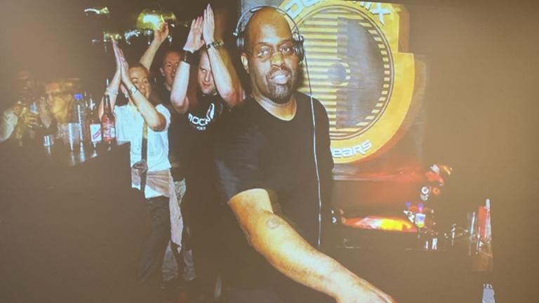 A photo of Frankie Knuckles is on display at an event commemorating the digitization of his vinyl record collection. (Angel Idowu / WTTW News)