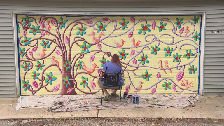 Evanston artist Teresa Parod paints a mural on a garage door. (WTTW News) Evanston artist Teresa Parod paints a mural on a garage door. (WTTW News)