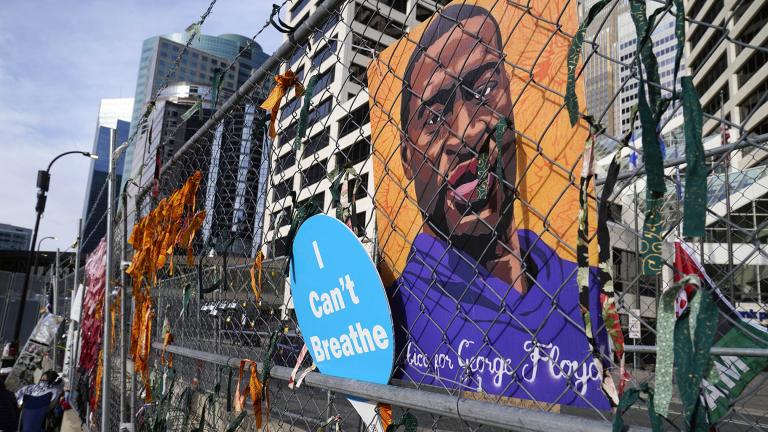 A picture of George Floyd hangs on a fence outside the Hennepin County Government Center, Tuesday, March 30, 2021, in Minneapolis where the trial for former Minneapolis police officer Derek Chauvin continues. (AP Photo / Jim Mone)