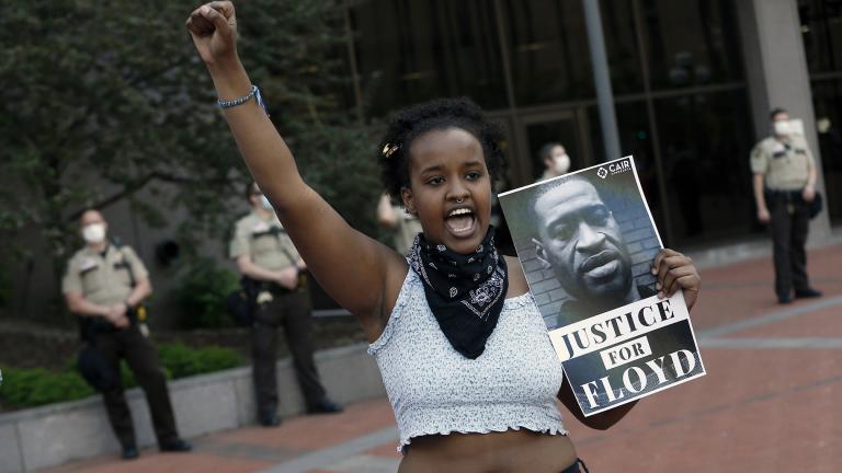 In this Thursday, May 28, 2020, file photo, a protester holds a photo of George Floyd during a protest at the Hennepin County Government Center, as protests continue over the death of Floyd, who died in police custody Monday night in Minneapolis, after video shared online by a bystander showed a white officer kneeling on his neck during his arrest as he pleaded that he couldn’t breathe. (AP Photo / Jim Mone, File)