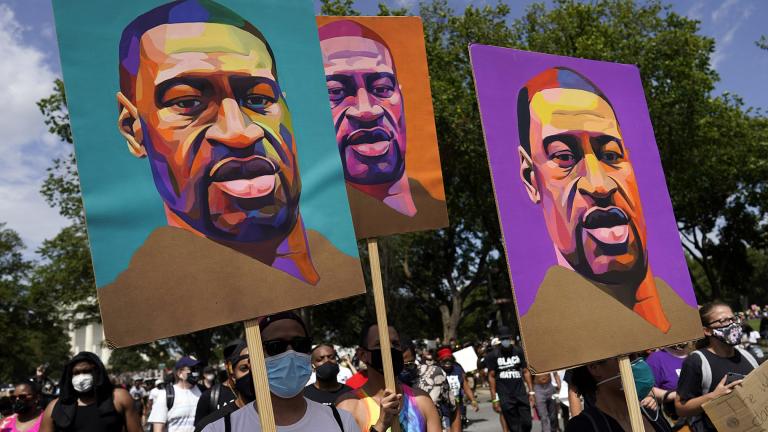 In this Aug. 28, 2020, file photo, people carry posters with George Floyd on them as they march from the Lincoln Memorial to the Martin Luther King Jr. Memorial in Washington. (AP Photo / Carolyn Kaster, File)