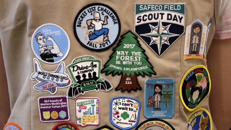 In this June 18, 2018, file photo, patches cover the back of a Girl Scout’s vest at a demonstration of some of their activities in Seattle. (AP Photo / Elaine Thompson, File)