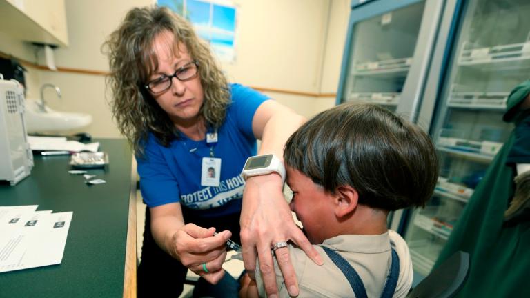A registered nurse and immunization outreach coordinator with the Knox County Health Department, administers a vaccination to a kid at the facility in Mount Vernon, Ohio, Friday May 17, 2019. (AP Photo / Paul Vernon, File)
