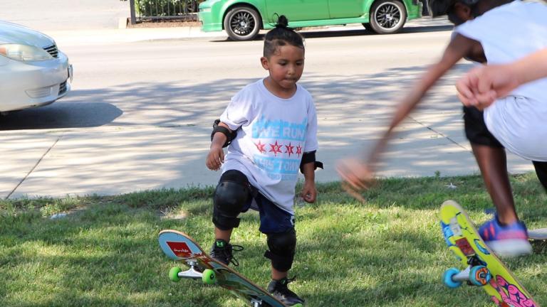 Attendees of the Go Grind youth skate camp practice tricks on the grass of Piotrowski Skate Park in Chicago. (Evan Garcia / WTTW News) Attendees of the Go Grind youth skate camp practice tricks on the grass of Piotrowski Skate Park in Chicago. (Evan Garcia / WTTW News)