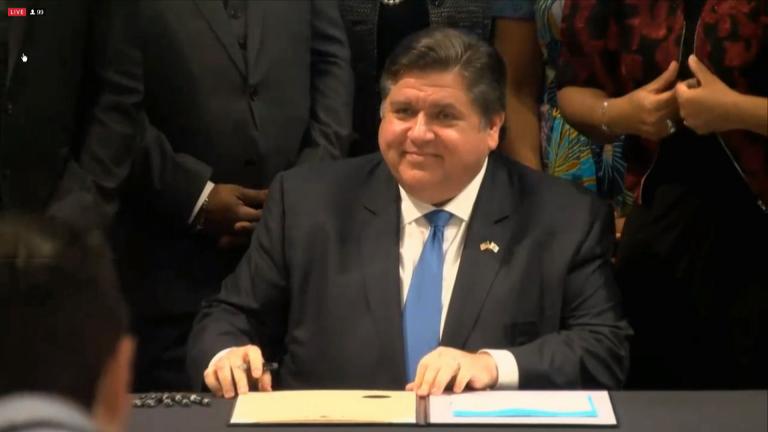 Gov. J.B. Pritzker signs House Bill 3922 on Wednesday, June 16, 2021 at the Abraham Lincoln Presidential Library and Museum in Springfield. The new law makes Juneteenth an official state holiday. (WTTW News via the Governor’s Office)