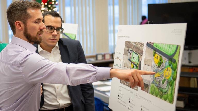 Project Manager Justin Rossman of Site Design Group explains the highlights of Ashe Elementary School’s planned garden to Dean Alonistiotis, aide to MWRD Commissioner Kimberly Du Buclet. (Courtesy Metropolitan Water Reclamation District of Greater Chicago)