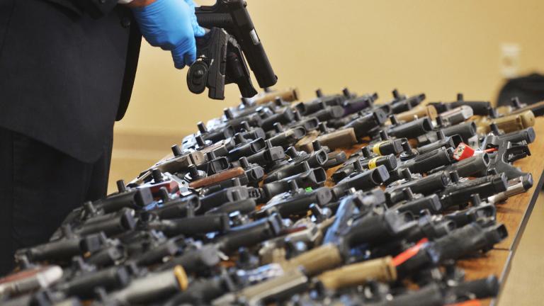 Dozens of recovered stolen handguns are displayed during a press conference, Nov. 21, 2023, in Benton Township, Mich. (Don Campbell / The Herald-Palladium via AP, File)