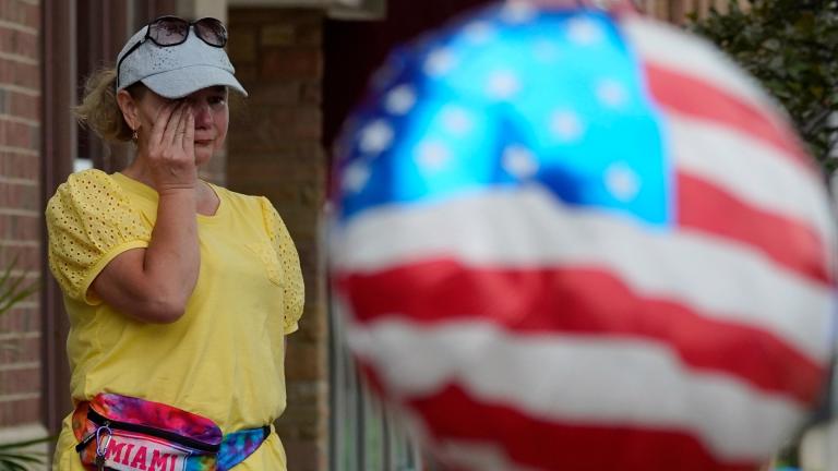 A woman wipes away tears after a mass shooting at an Independence Day parade that left seven people dead and dozens wounded, in the Chicago suburb Highland Park, July 4, 2022. (AP Photo / Nam Y. Huh, File)