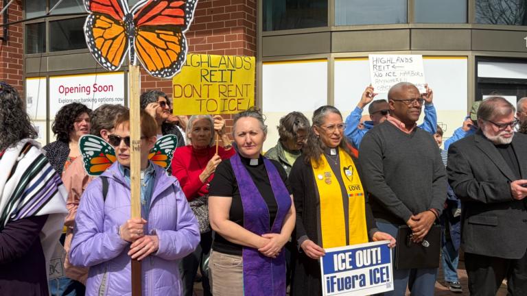 Clergy members, community members, and worker and immigrant rights advocates gather at Sherman Plaza in Evanston on March 20, 2026, to protest Chicago-based real estate investment group Highlands REIT over potential plans for its Colorado correctional facility to be used by U.S. Immigration and Customs Enforcement. (Eunice Alpasan / WTTW News)