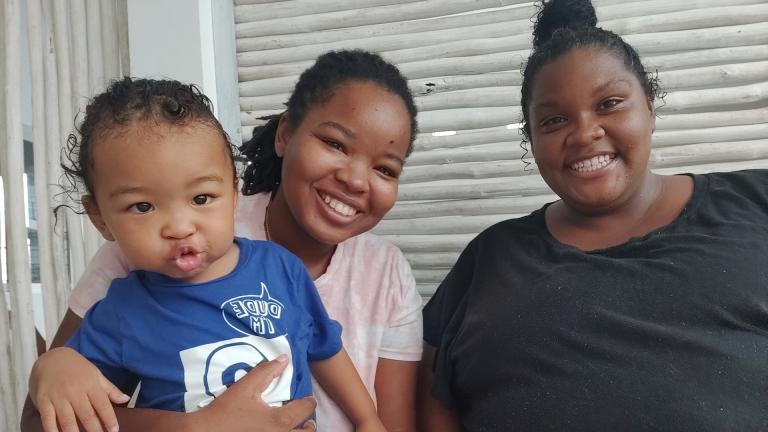 Corritta Lewis, center, and her wife Mea pose with their son Caleb, 2, in Oceanside, Calif., on Dec. 4, 2020. (Corritta Lewis via AP)