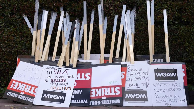 Placards are gathered together at the close of a picket by members of The Writers Guild of America outside Walt Disney Studios, Tuesday, May 2, 2023, in Burbank, Calif. On Sunday, Sept. 24, 2023, a tentative deal was reached to end Hollywood’s writers strike after nearly five months. (AP Photo/Chris Pizzello, File)