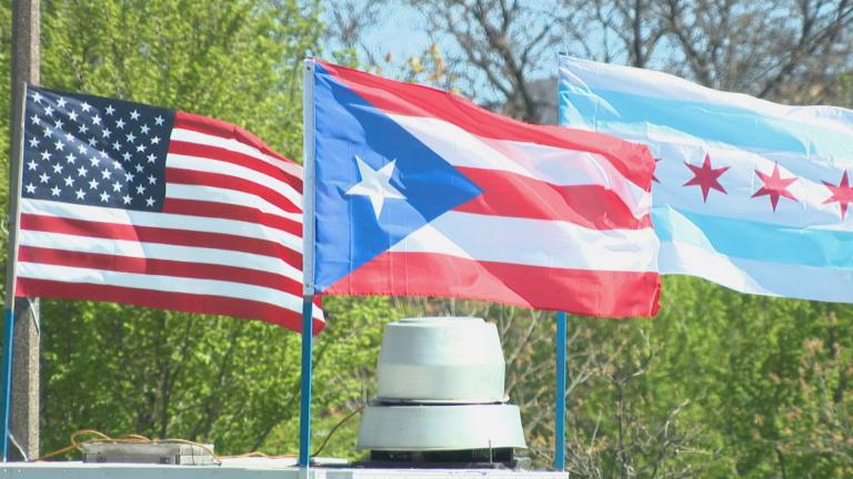 The flag of Puerto Rico flies alongside the U.S. flag and Chicago flag in Humboldt Park. (WTTW News)