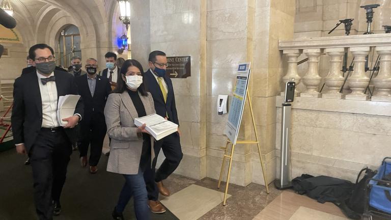 Ald. Silvana Tabares (23rd Ward) carries the map crafted by the City Council's Latino Caucus into the city clerk's office Thursday, Dec. 2, 2020. (Heather Cherone/WTTW News)