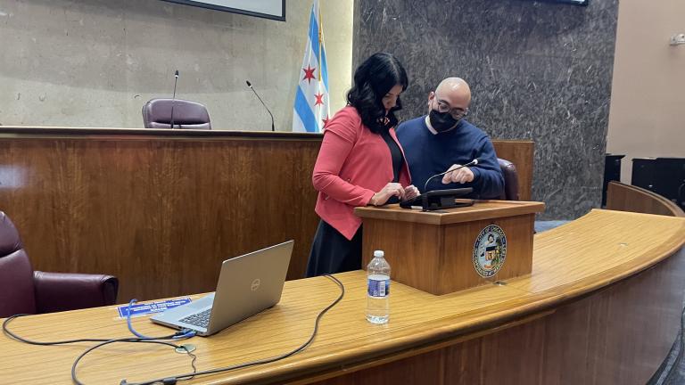 City Clerk Anna Valencia and Roberto Lopez, director of project managment test the new electronic voting system to be used by members of the Chicago City Council on Monday, March 21. (WTTW News/Heather Cherone)